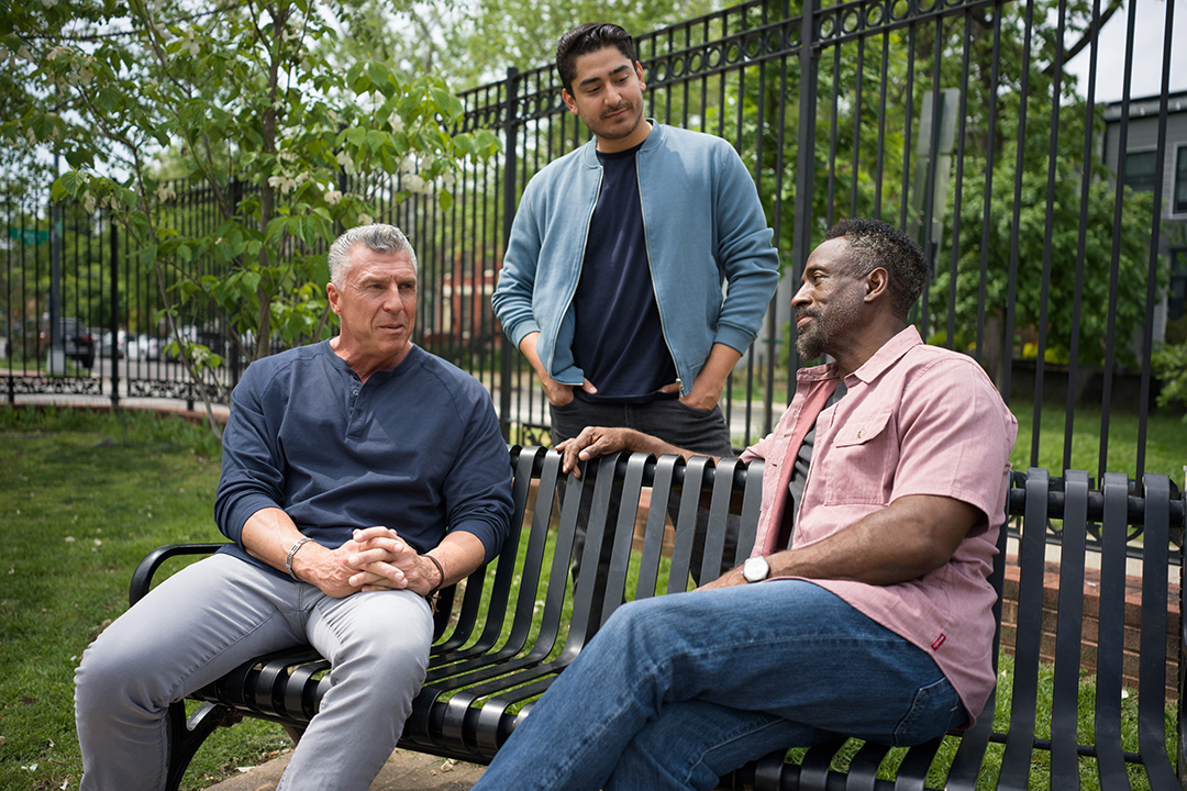 Three Veterans sitting outside talking
