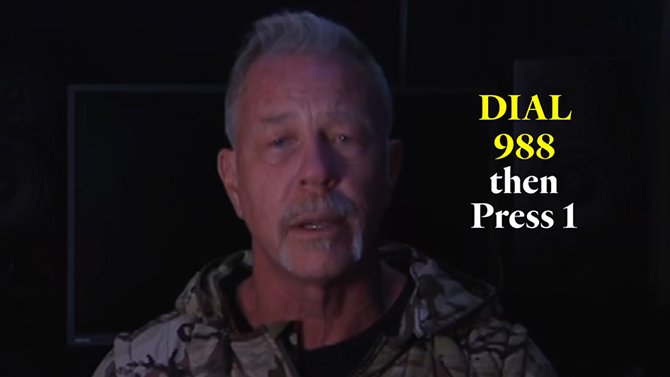 Metallica lead singer speaking towards camera with text 'dial 988 then press 1'