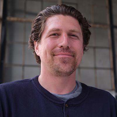 White male with dark smiling at the camera
