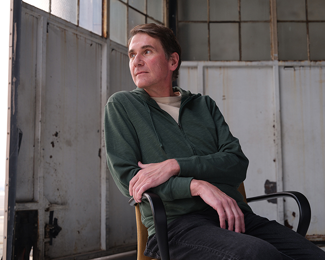 Veteran Myles sitting in a chair looking off to the left.