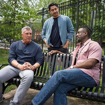 Veterans sitting outside on a bench having a conversation